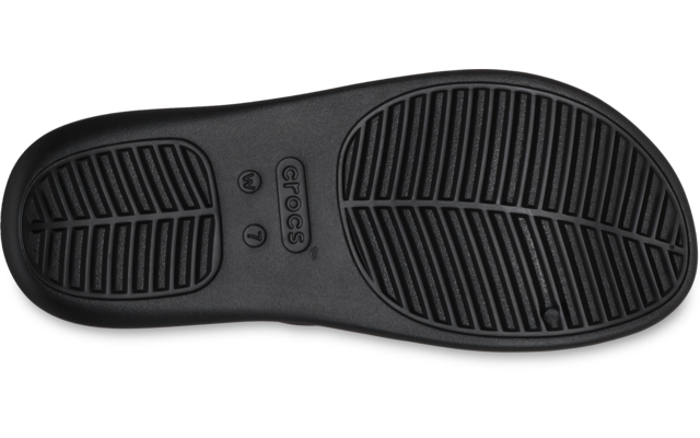 Suela de zapato negra con dibujo y marca 'Crocs', sobre fondo blanco