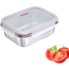 Boîte rectangulaire en acier inoxydable avec couvercle transparent et joint d'étanchéité rouge, à côté deux tranches de tomate et une tomate entière avec feuilles vertes