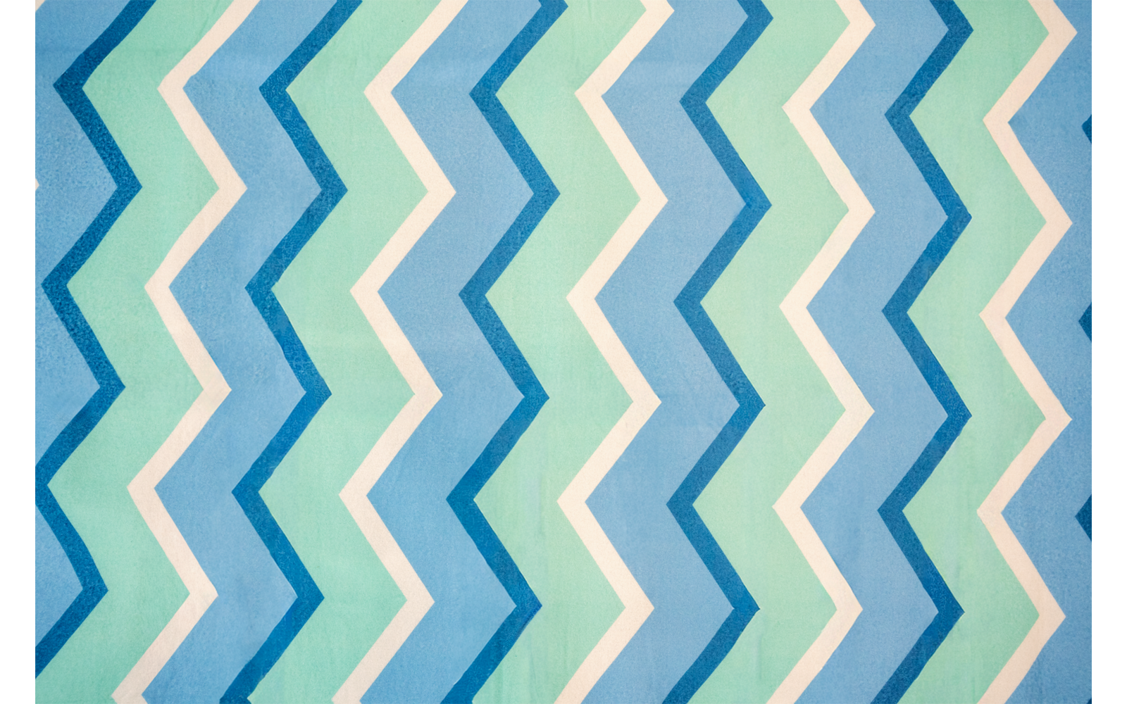 Wiederholtes Zickzackmuster in Blau, Grün und Weiß