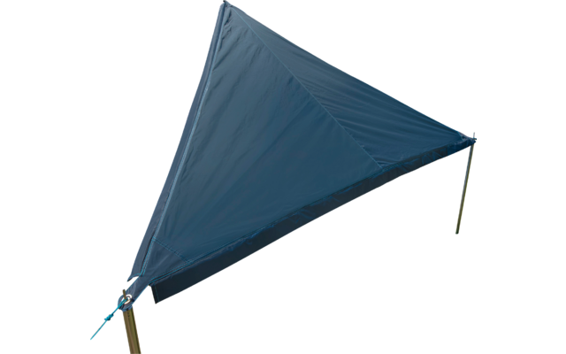 Blue triangular sunshade on a grassy field with trees in the background