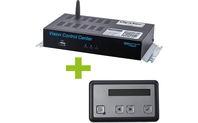 Schwarzes rechteckiges Gerät mit Antenne, Lüftungsöffnungen und blauer Aufschrift 'Vision Control Center', weißer Aufkleber; grünes Pluszeichen; graues Bedienfeld mit Display und vier Tasten