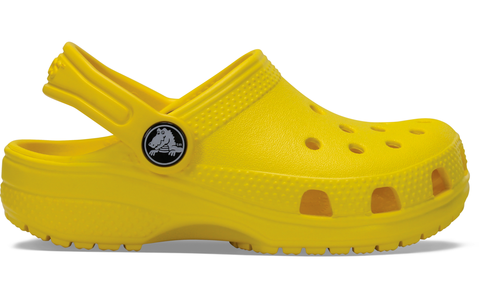 Sabot jaune en vue de côté, trous d'aération sur le dessus et le côté, semelle texturée et bride de talon avec bouton rond