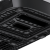 Underside of a black device with a grid pattern, ventilation openings, several rectangular recesses, and small labeled tabs