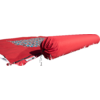 Red rolled-up yoga mat lying on grass