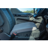 Gray seat cushion on a front car seat; visible seatbelt, door panel with handle, steering wheel and key in the ignition, outside window showing trees