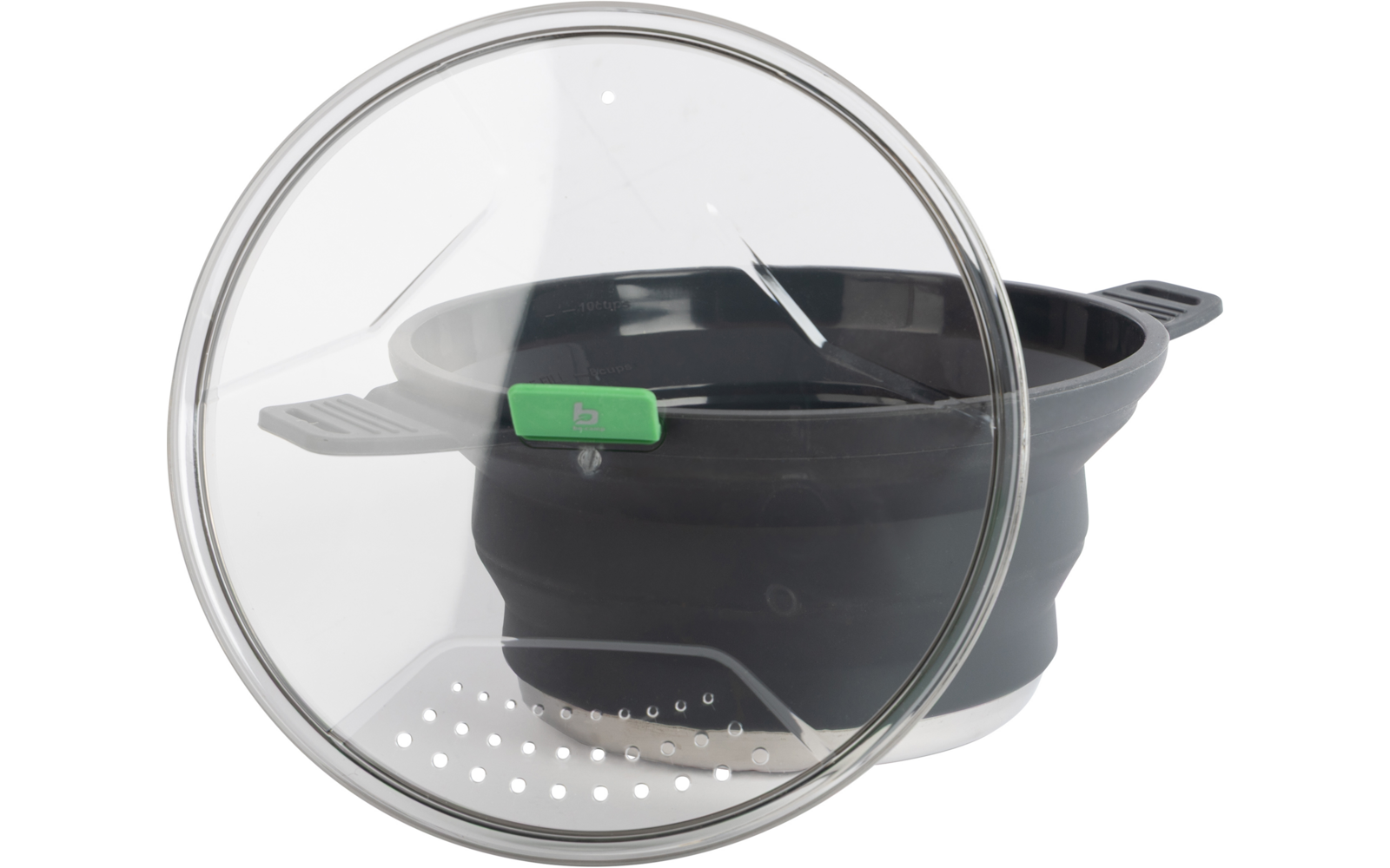 Transparant glazen deksel met metalen rand leunt voor een ingeklapte zwarte siliconen bak met twee handvatten; groene plastic clip op de rand en witte geperforeerde inzetplaat onderin zichtbaar