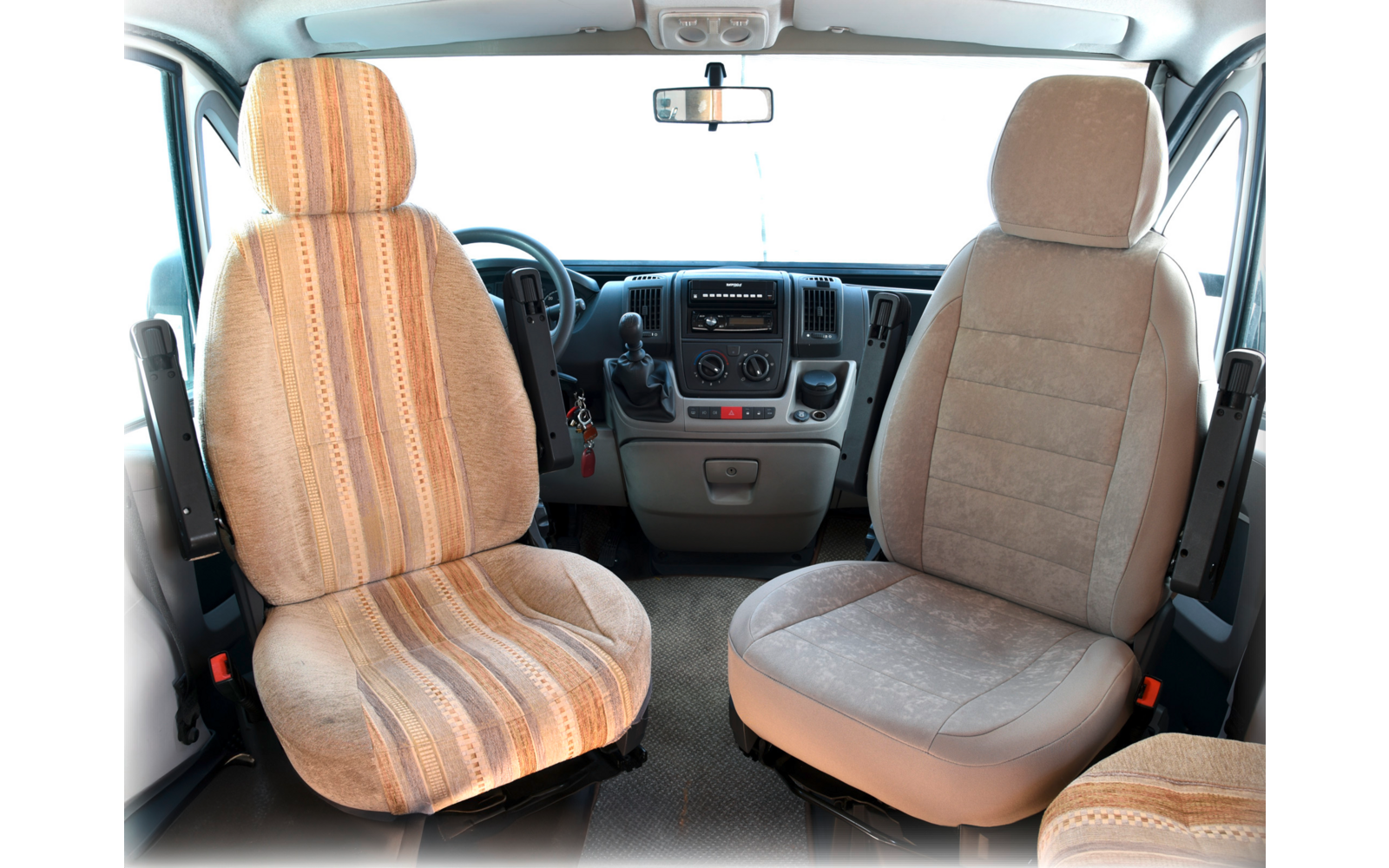 Interior of a vehicle with two front seats, a steering wheel, and a dashboard