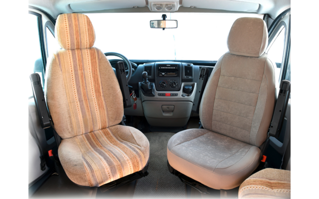Interior of a vehicle with two front seats, a steering wheel, and a dashboard