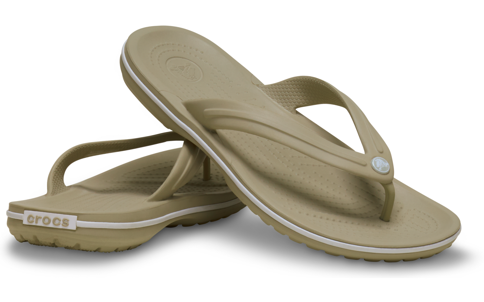 Zwei beige Flip‑Flops aus Gummi, übereinander gelegt, mit genoppter Fußsohle, schmalem Zehensteg und rundem Logo auf dem Riemen