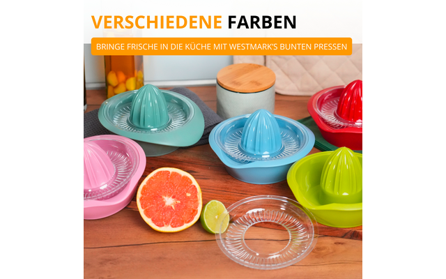 Plusieurs presse-agrumes manuels en plastique coloré sur un plan de travail en bois, un pamplemousse et un citron vert coupés en deux, une pièce de presse en verre transparent, deux bocaux de rangement avec couvercles en bois en arrière-plan