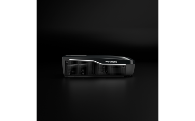 Schwarzes rechteckiges Gerät mit Lüftungsgittern und Schriftzug 'DOMETIC' auf dunklem Hintergrund