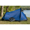Blue tent with black base and yellow guy lines on grass at a lakeshore, trees in the background