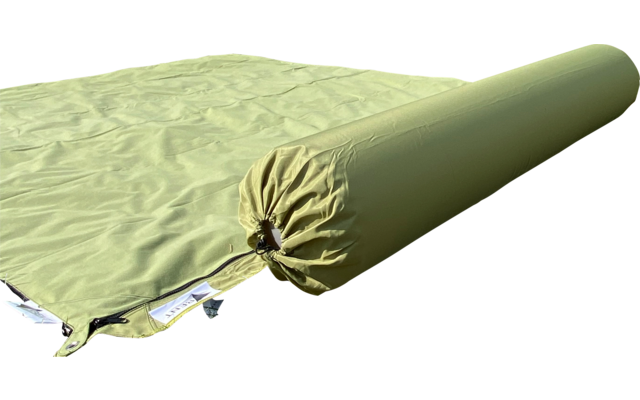 Greenish rolled-up sleeping pad inner section lying on an unrolled sleeping pad on grass