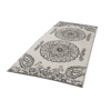 Alfombra rectangular blanca con tres grandes motivos ornamentales circulares negros y decoraciones paisley en los extremos