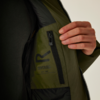 Hand öffnet die Innenseite einer Jacke mit sichtbarem Etikett