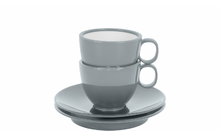 Deux tasses grises empilées sur deux soucoupes grises sur fond blanc