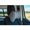Gray butterfly-shaped neck pillow attached to the headrest of a black car seat; car window showing fields and blue sky