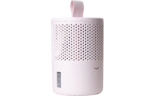 Altavoz portátil rosa con asa de transporte y patrón perforado