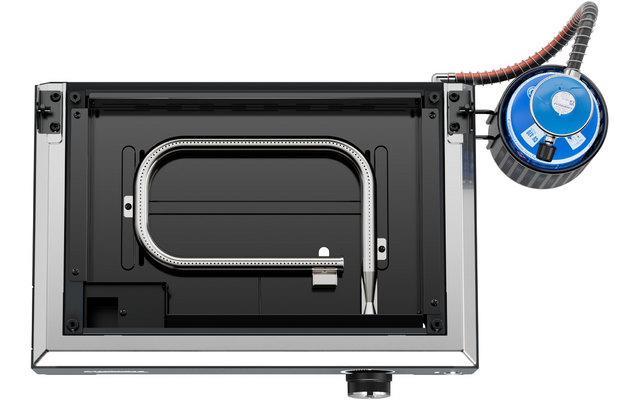 Rectangular metal housing with black interior, containing an oval silver metal tube loop; top right a round blue device with a corrugated black hose and a black control knob at the bottom edge