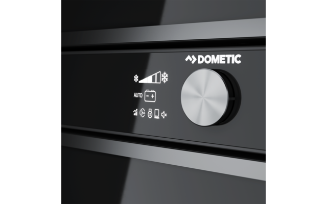 Nahaufnahme eines schwarzen glänzenden Bedienfelds mit silbernem Drehknopf rechts, weißem DOMETIC-Logo und weißen Symbolen links: Temperaturbalken mit Schneeflocken, 'AUTO', Batterie-Symbol und weitere kleine Symbole