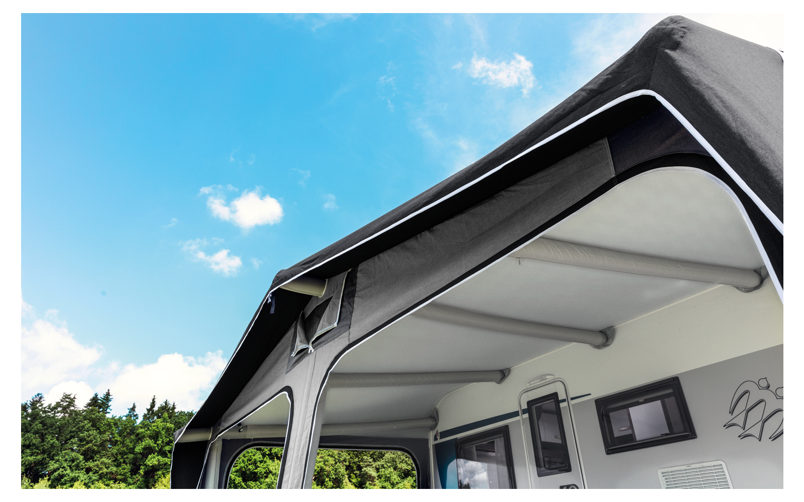 Tent with open entrance under a blue sky with few clouds