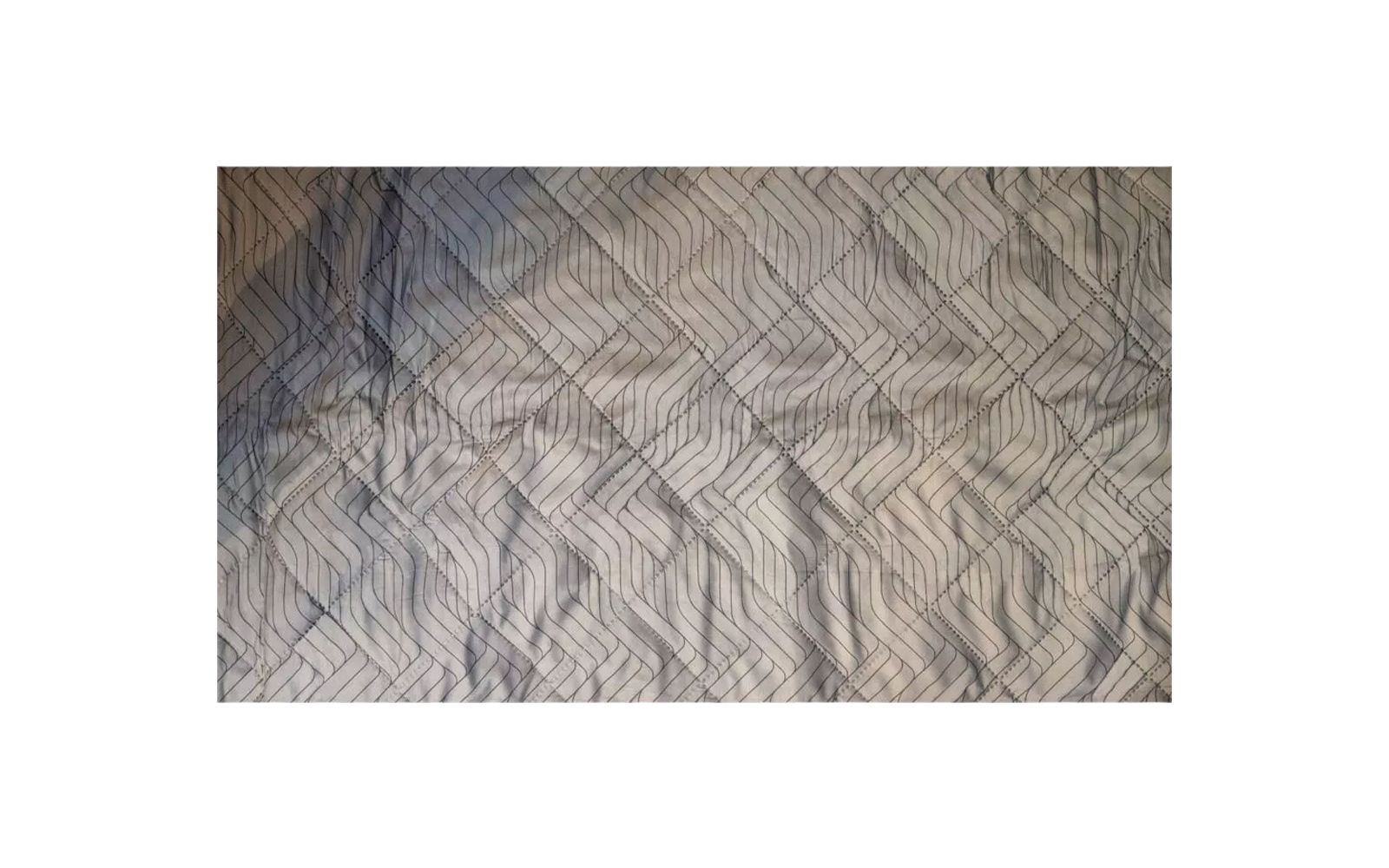 Braune und graue Stoffoberfläche mit gestepptem Rautenmuster