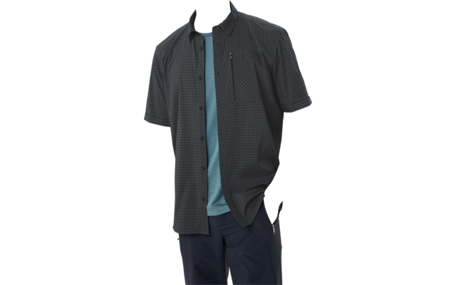 Persona con camisa de cuadros oscura de manga corta sobre una camiseta turquesa, manos en los bolsillos, mirando de lado sobre fondo blanco