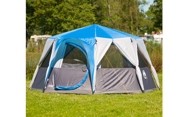 Blue and gray tent on green grass in sunny weather
