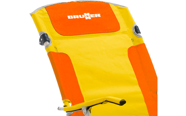 Yellow-orange chair with white "BRUNNER" logo on the headrest, orange padded sections, visible silver metal frame and armrests