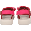 Rear view of a pair of pink sandals with Velcro straps and white soles on a white background