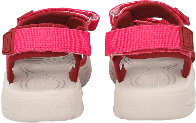 Rear view of a pair of pink sandals with Velcro straps and white soles on a white background