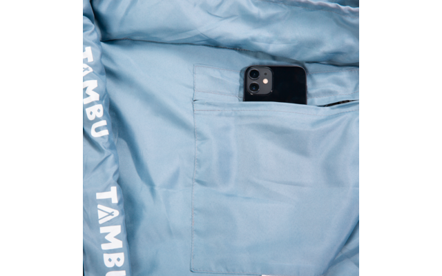 Light blue jacket lining with an inner pocket holding a black smartphone; white text 'TAMBU' on the hem