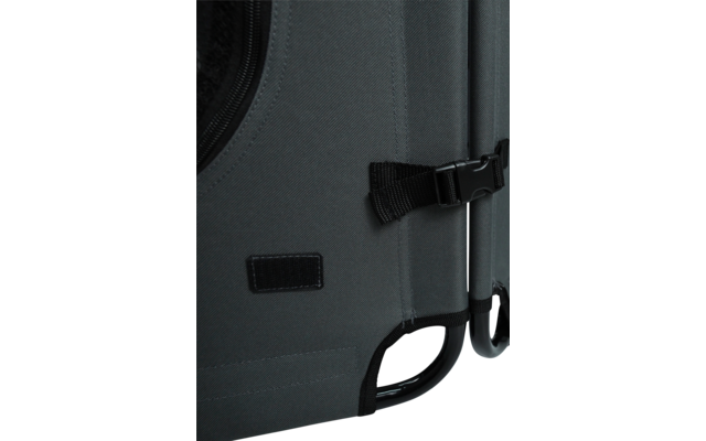 Close-up of a grey fabric panel with zipper edge, black strap with plastic buckle, stitched seams, small rectangular Velcro patch and black plastic frame