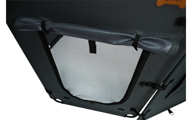 Grey fabric opening with rectangular mesh window, rolled-up flap at top secured by a black strap, visible zipper and buckles