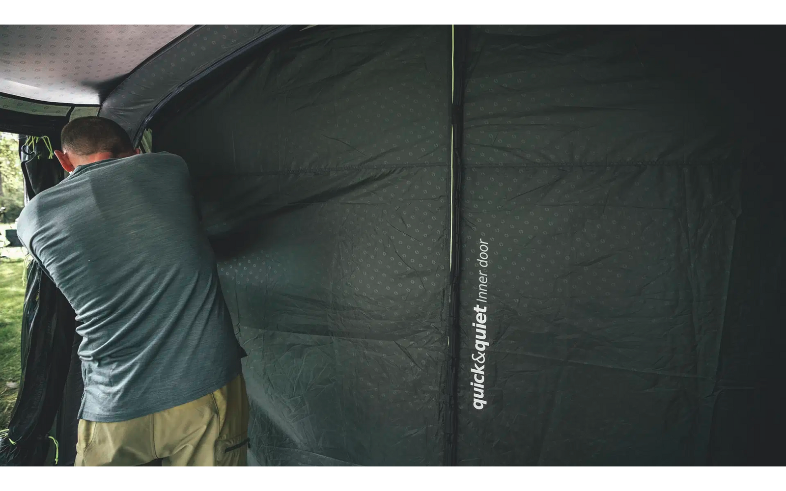 Mann hämmert auf ein schwarzes Zelt