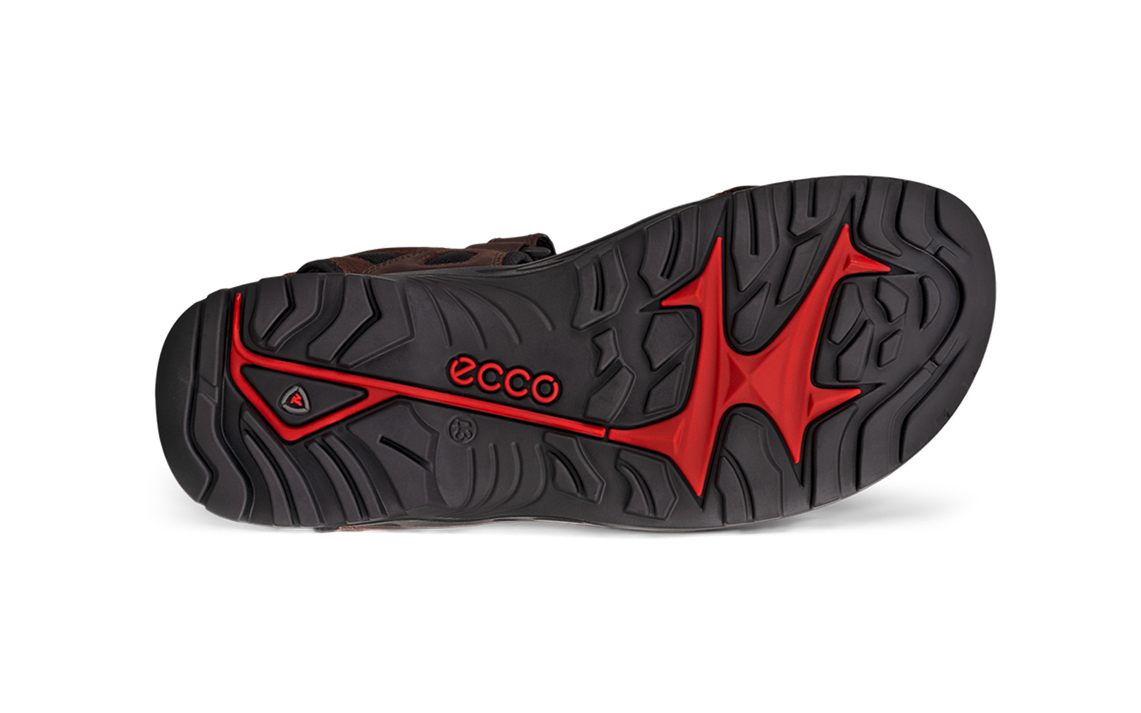 Semelle inférieure de chaussure noire vue de dessous avec inserts rouges et motif de crampons, inscription "ecco" visible