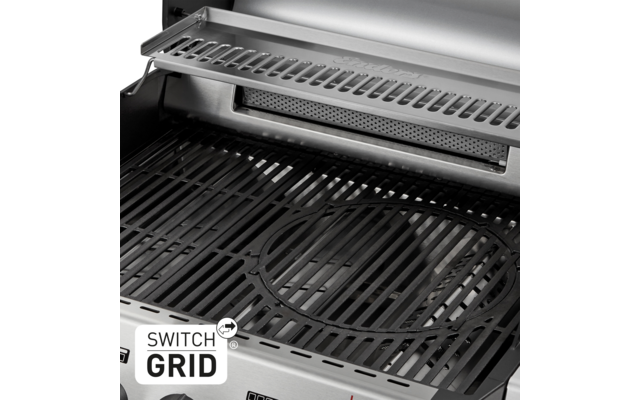 Nahaufnahme des Inneren eines Edelstahlgrills mit gusseisernem Grillrost, rundem Mitteleinsatz, Aufsatzrost oben und Schriftzug "SWITCH GRID"
