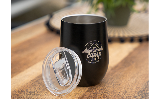 Black insulated cup with removable transparent lid, placed on wooden surface