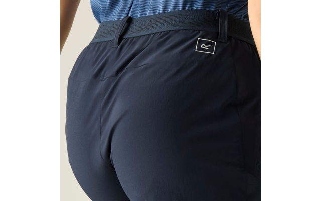 Nahaufnahme, Rückenansicht einer Person mit dunkelblauer Hose, sichtbarem Taillenbund, Gürtelschlaufen und kleinem Logo am hinteren Hosenbund