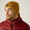 Persona con gorro de punto amarillo y chaqueta acolchada roja, barba corta, mirada hacia la izquierda