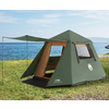 Green camping tent with open entrance and awning on grass; sea in the background, rocks to the right, blue sky with clouds
