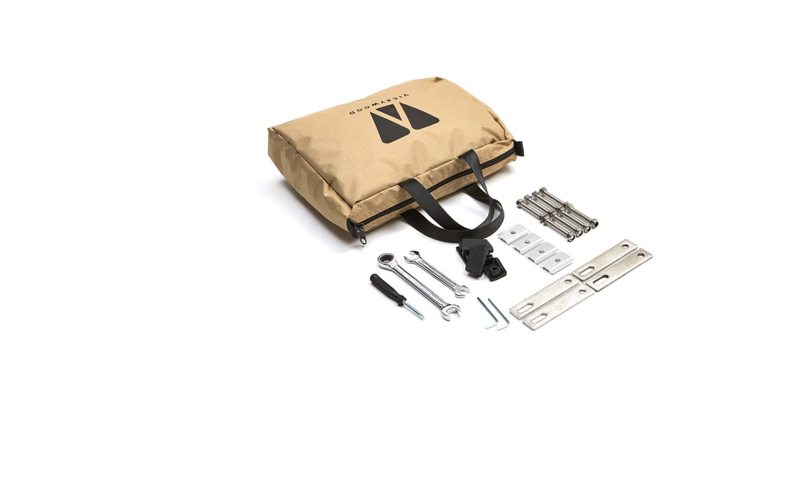 Beige Stofftasche mit schwarzen Tragegriffen und schwarzem Logo, daneben Schraubenschlüssel, Schraubendreher, Schrauben, Muttern und Metallwinkel auf weißem Hintergrund