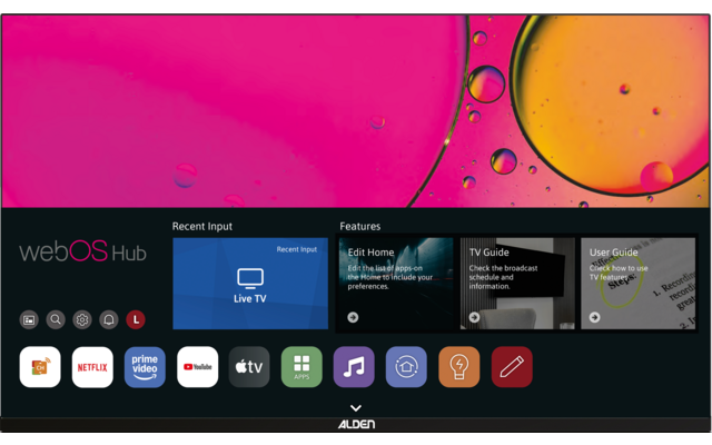 Fernsehbildschirm mit abstraktem buntem Hintergrund (rosa, gelb) und schwarzer Leiste unten mit Text 'webOS Hub', Kacheln 'Recent Input' und 'Features' sowie App-Symbole (Netflix, Prime Video, YouTube, Apple TV)