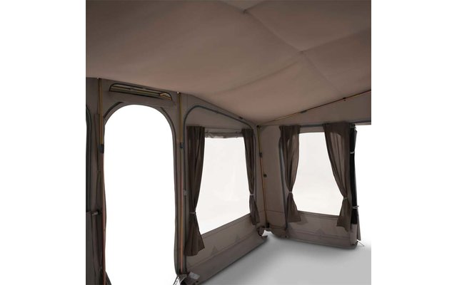 Interior of a tent with three rectangular windows with brown curtains, an arched open entrance on the left, light gray floor and fabric ceiling