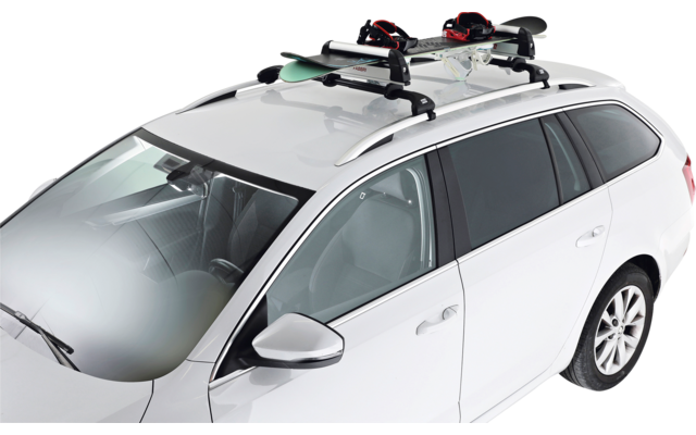 Station wagon bianca con portapacchi neri e due paia di sci sul tetto