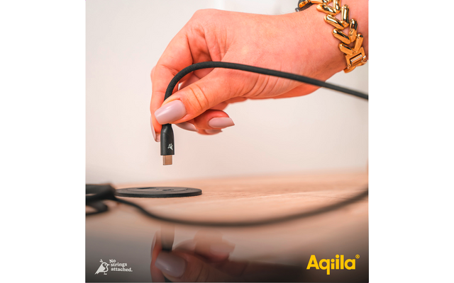 Hand hält ein mit einem Kabel verbundenes Audiosteckerende