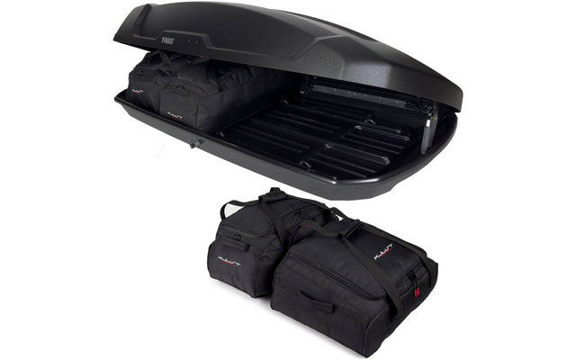 Geöffnete schwarze Dachbox mit Thule-Logo; zwei schwarze Reisetaschen im Inneren und zwei weitere vor der Box auf weißem Hintergrund