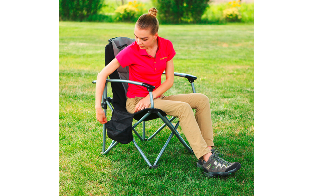 Garçon assis sur une chaise de camping en plein air