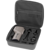 Open gray hard case with zipper; lid has a mesh pocket and a foam insert with cutouts holding a light gray handheld device and three black attachments