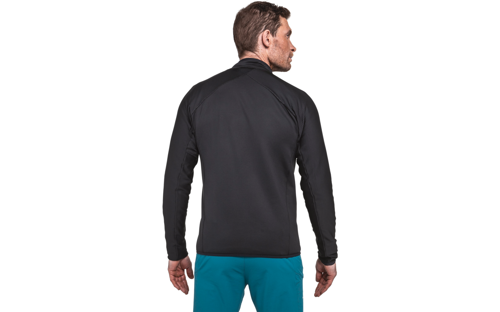 Person von hinten mit schwarzer Jacke und türkisblauer Hose, Kopf nach rechts gedreht